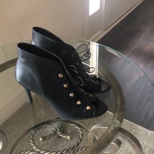 Black peep toe pump with gold button accents